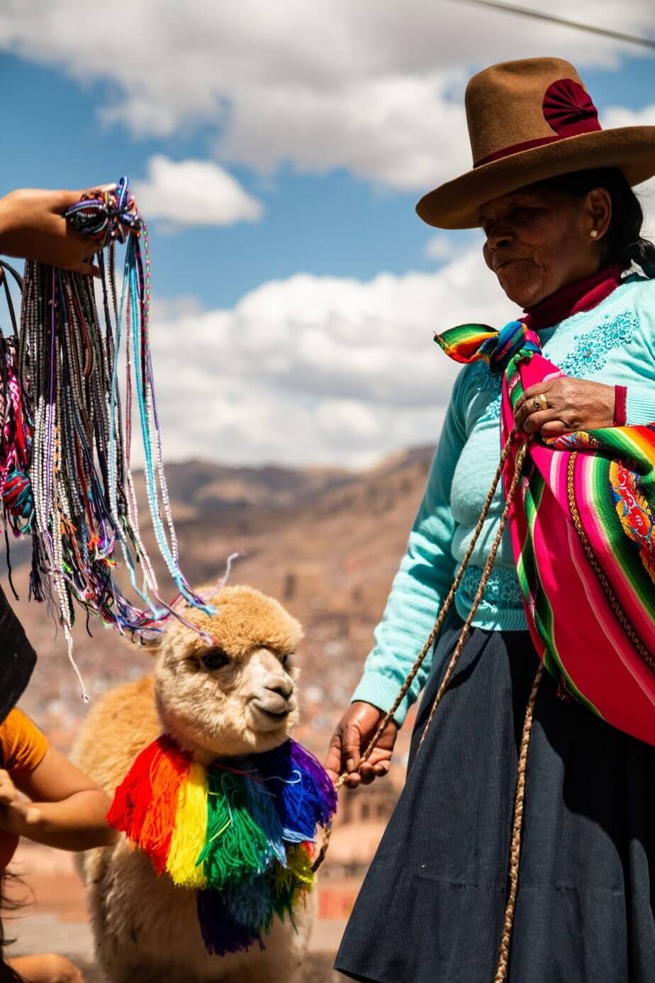 Travel Tips For Peru Woman and llama in Peru