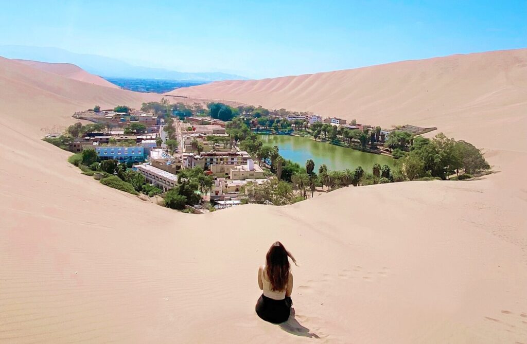 is lima worth visiting Camila Neves travel blogger at Huacachina Oasis, Peru