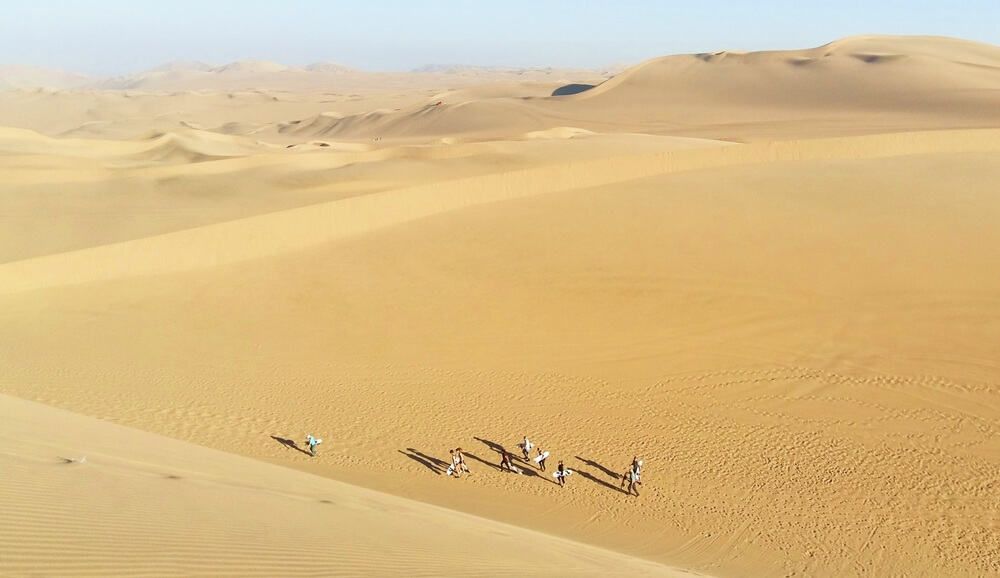 things to do in huacachina - People on the dunes in Huacachina